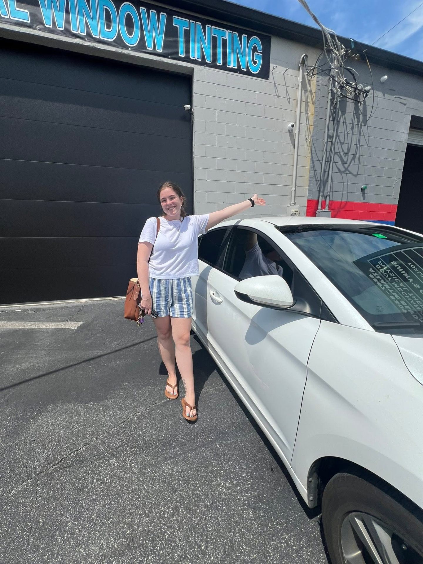 Happy Lifetime Tint customer with freshly finished vehicle