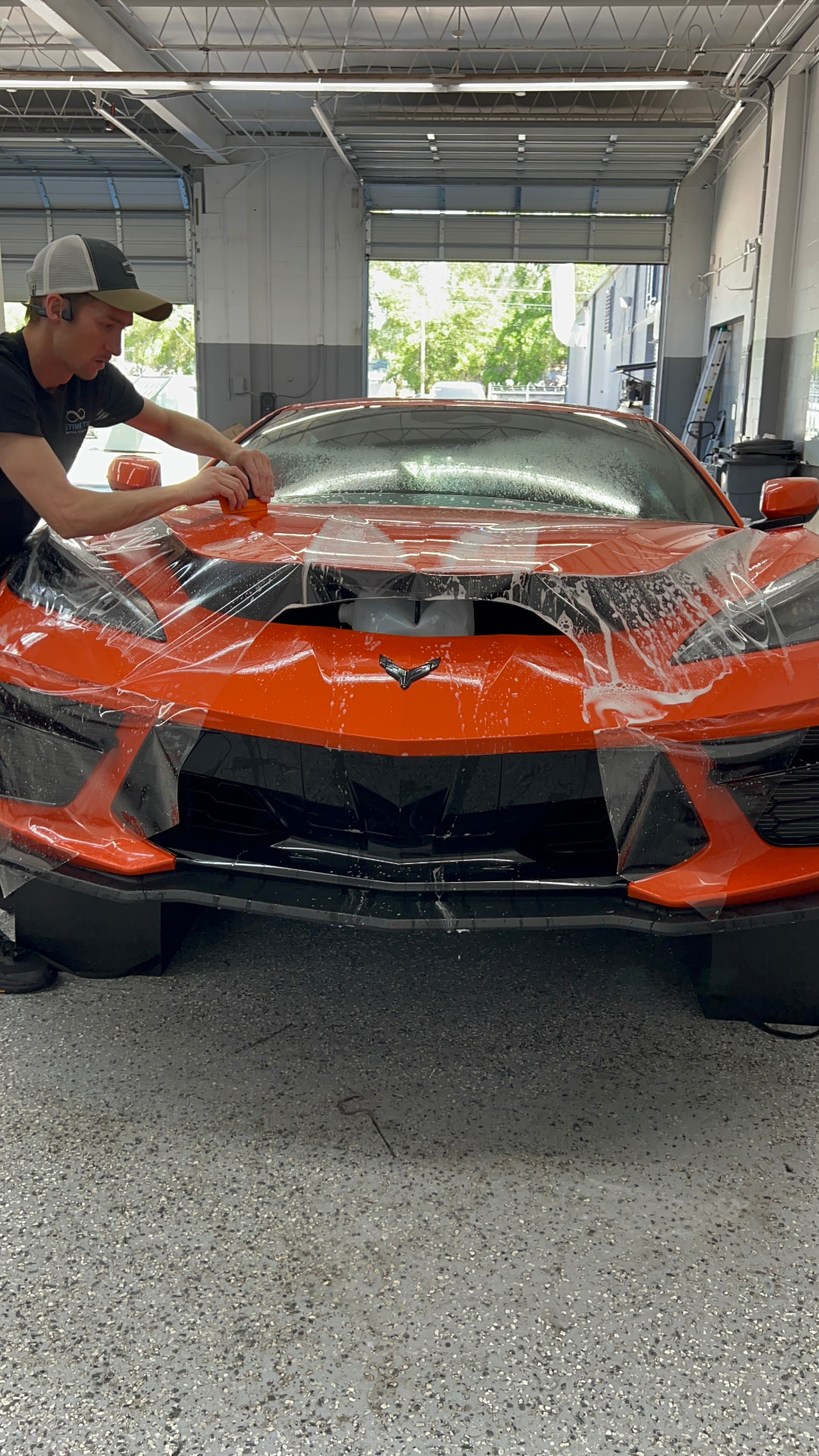 Installer applying paint protection film to a vehicle at Lifetime Tint in Jacksonville
